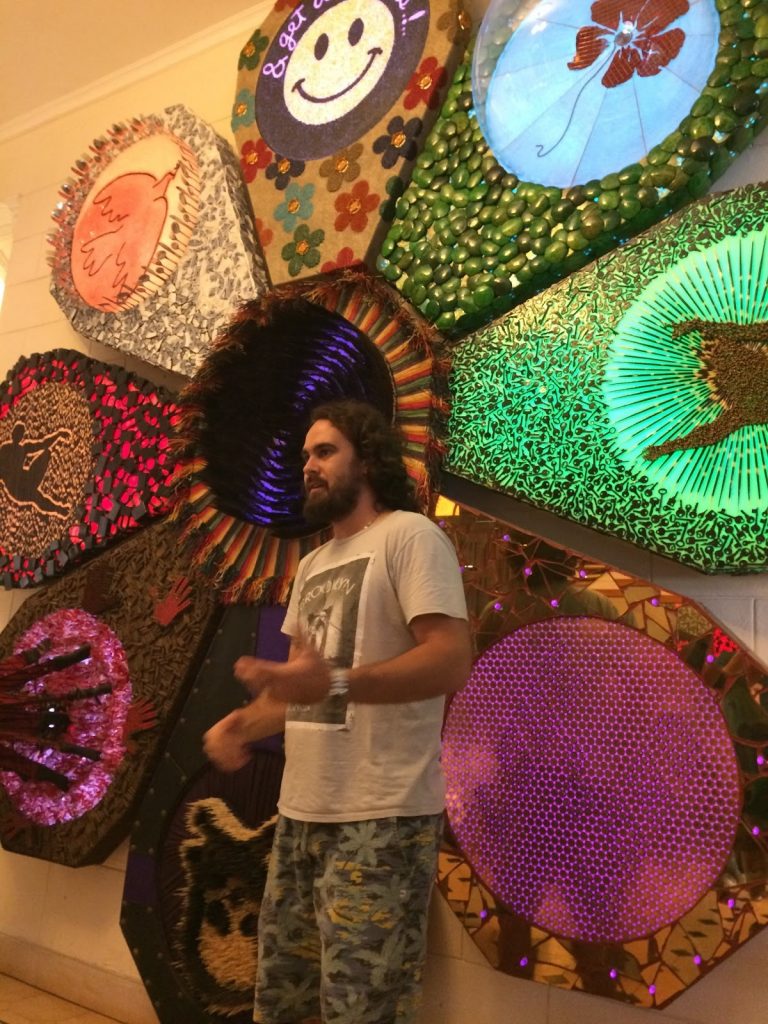 Artist Lorenzo Lopez in front of his art “Love Me, Love Me Not”