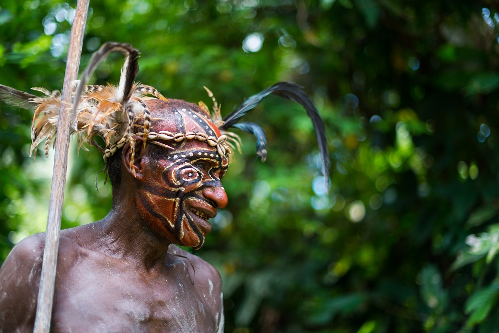 A Konmei villager in traditional costume, preparing for a ceremonial spirit dance. 